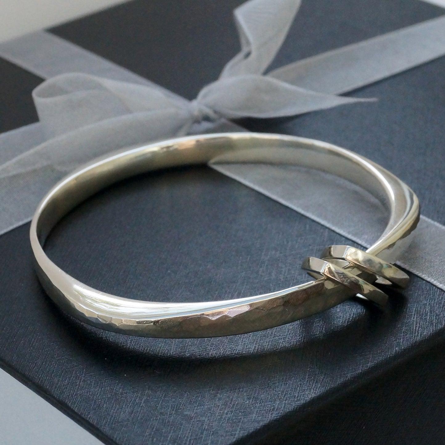 Silver Wide Flow bangle with triangle charms
