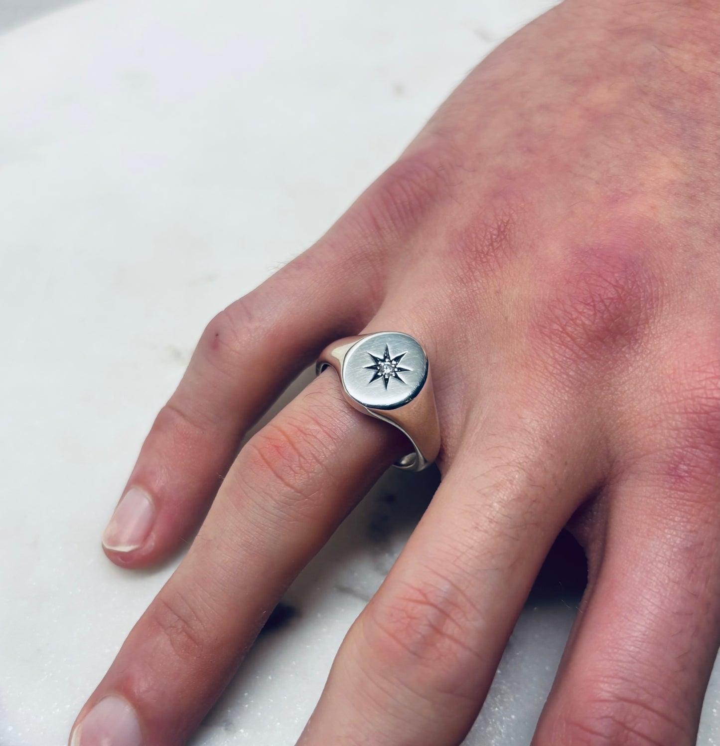 Oval star set diamond signet ring