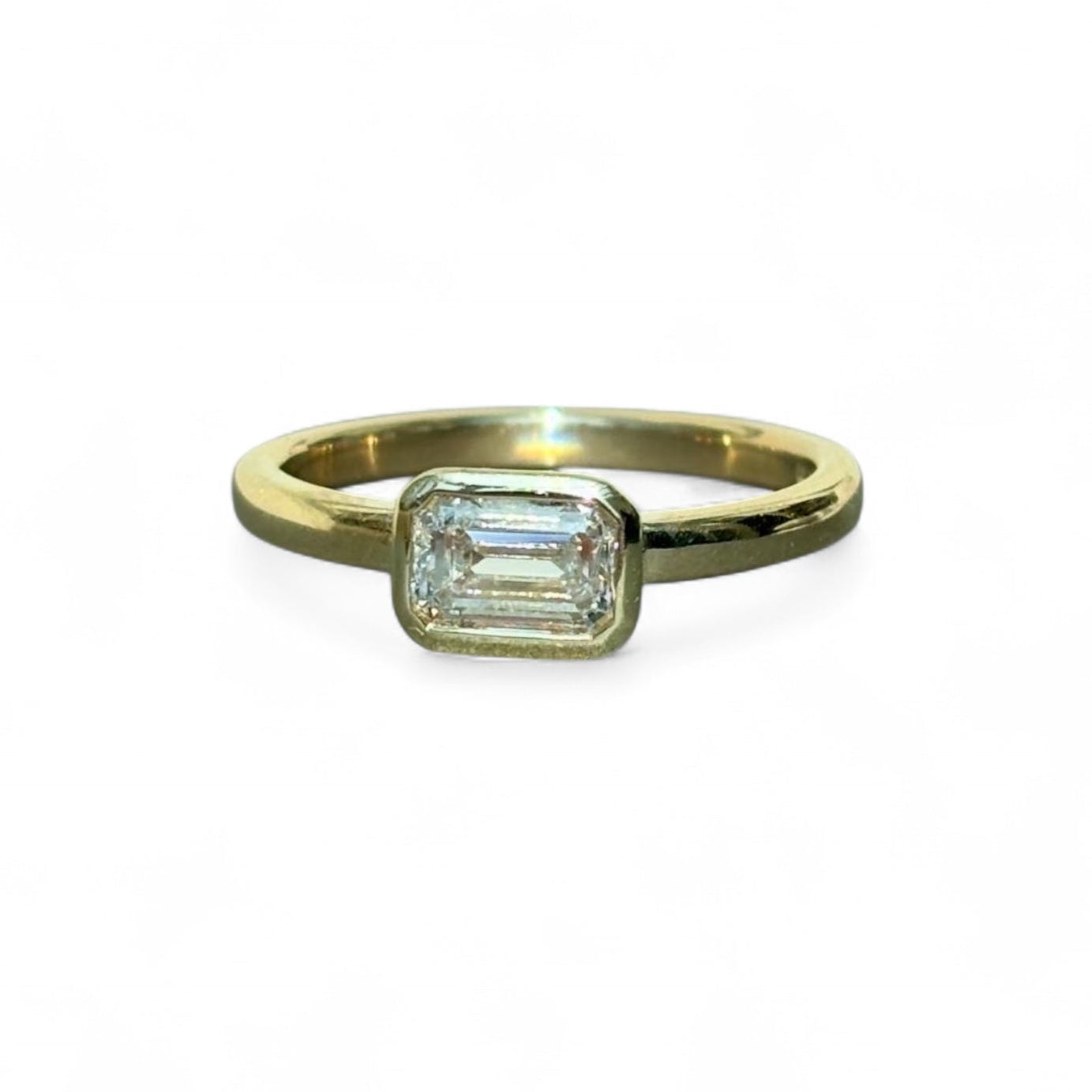 9ct Gold ring with emerald cut 0.50ct diamond on a white background