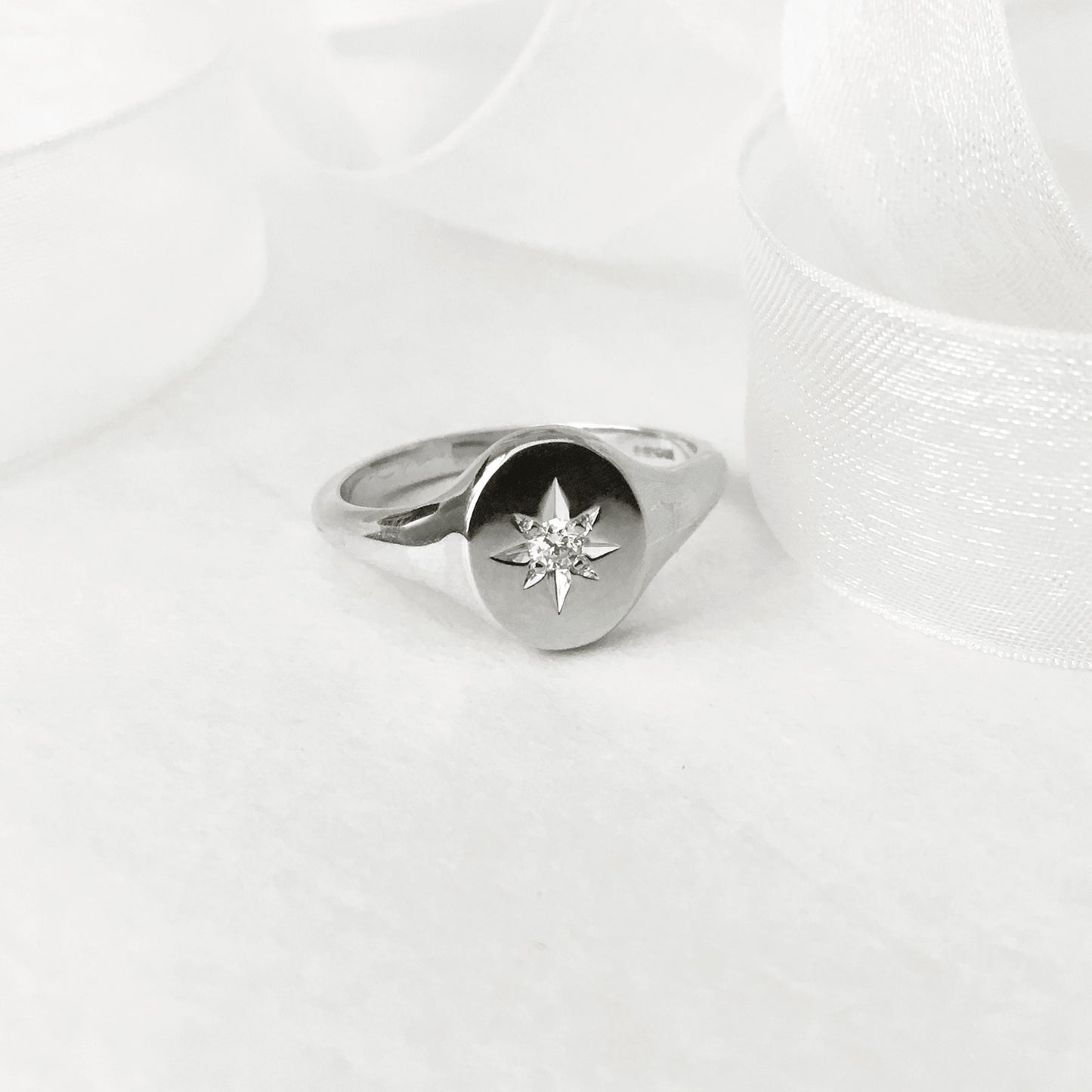 Oval star set diamond signet ring