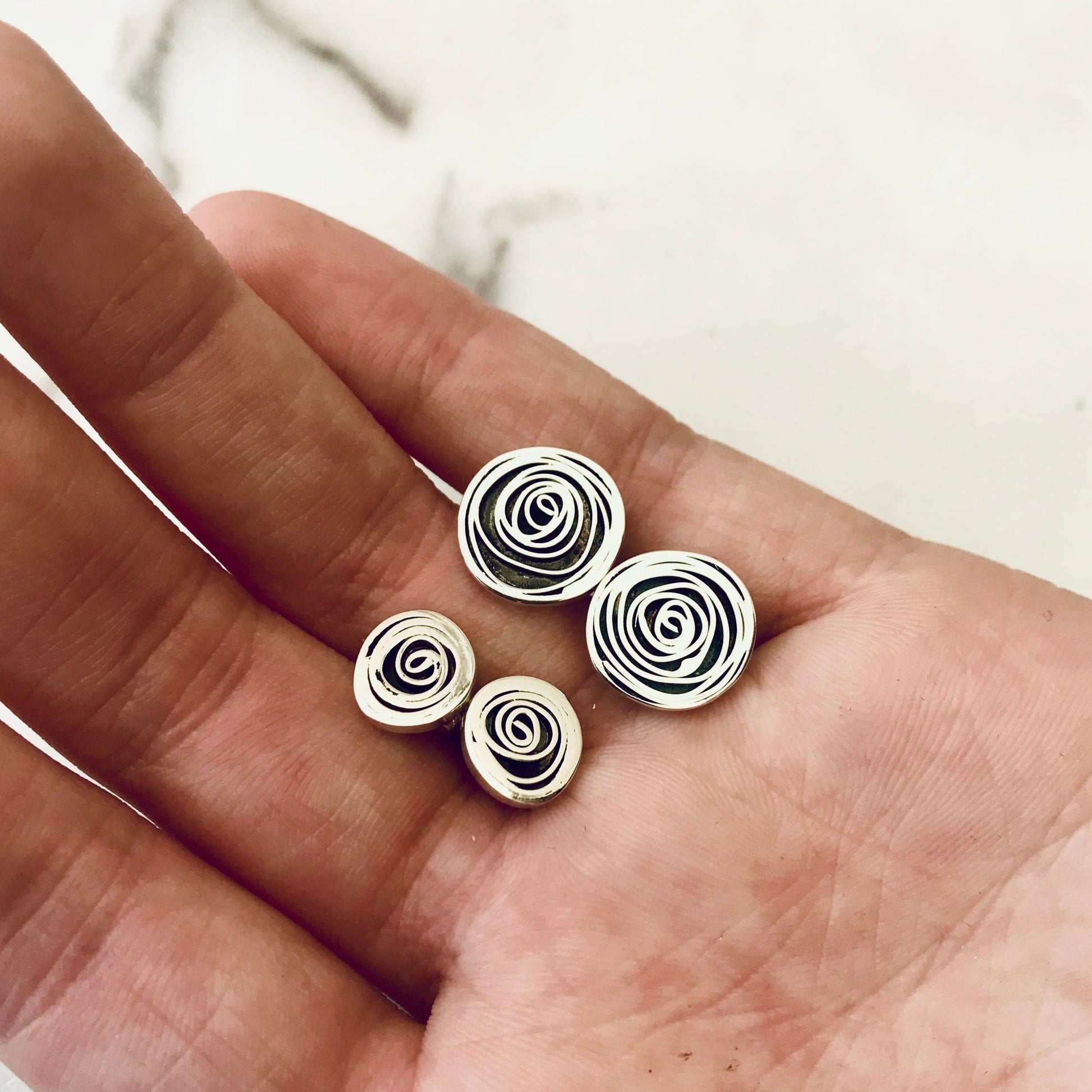 Hand coiled spirals of silver - oxidised inside